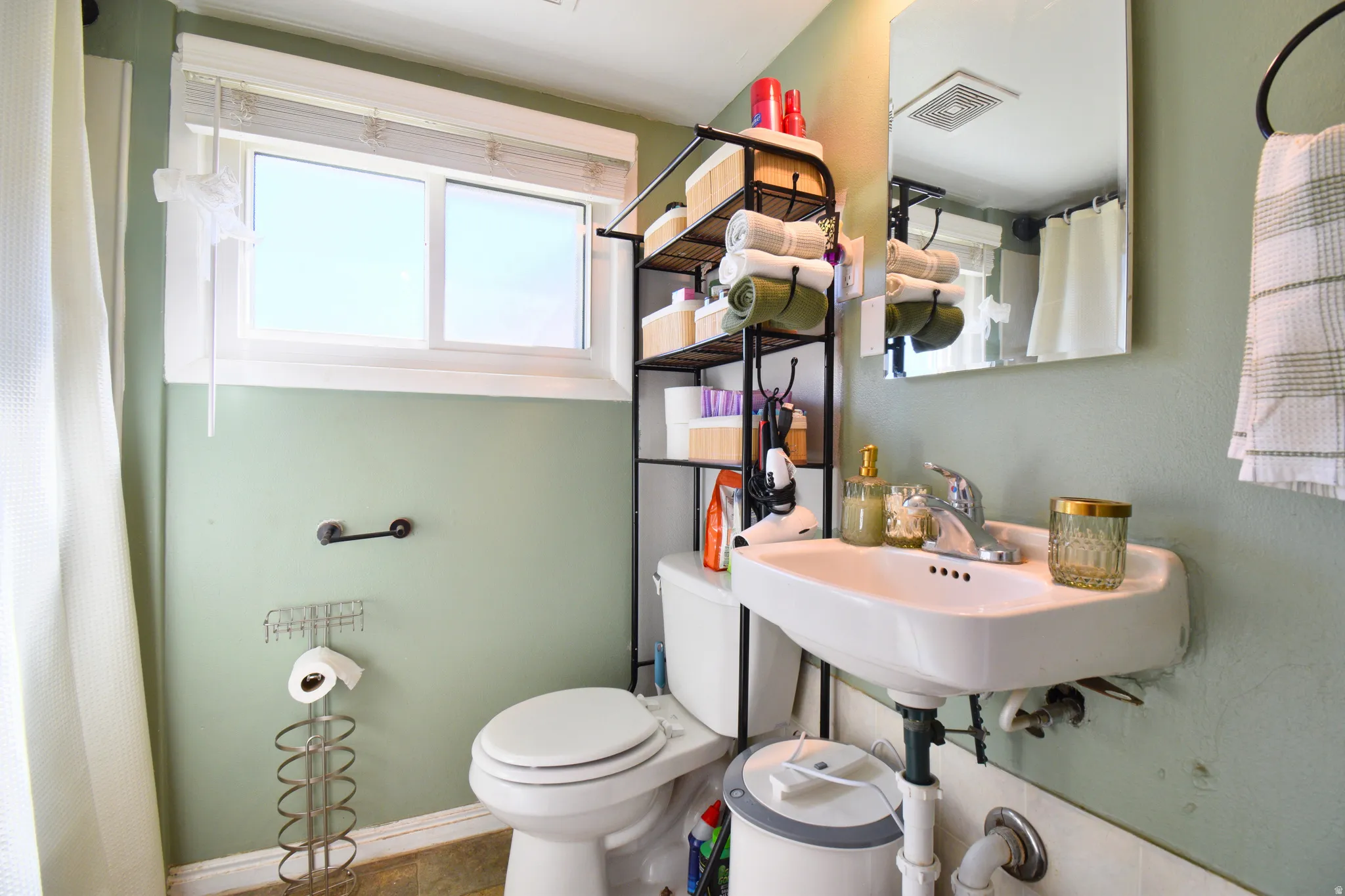 Bathroom featuring curtained shower and healthy amount of natural light