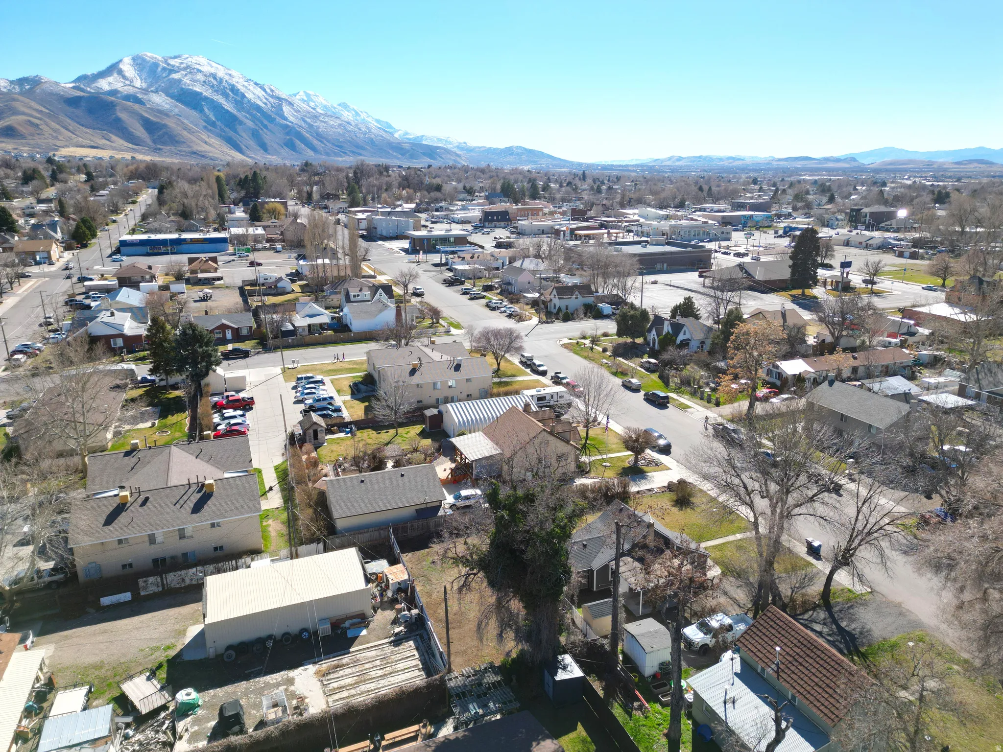 Aerial view of property's location featuring mountains and nearby suburban area