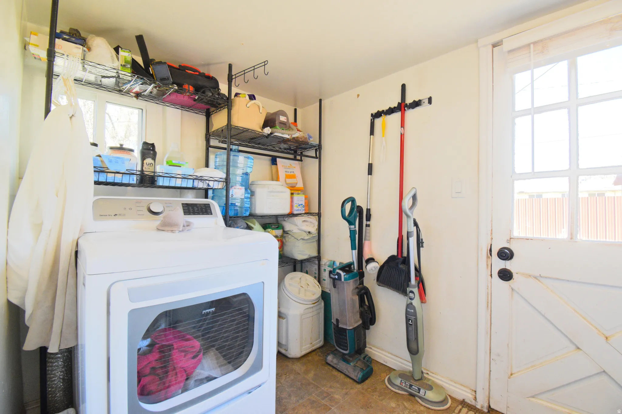 Laundry room featuring washer / dryer and baseboards