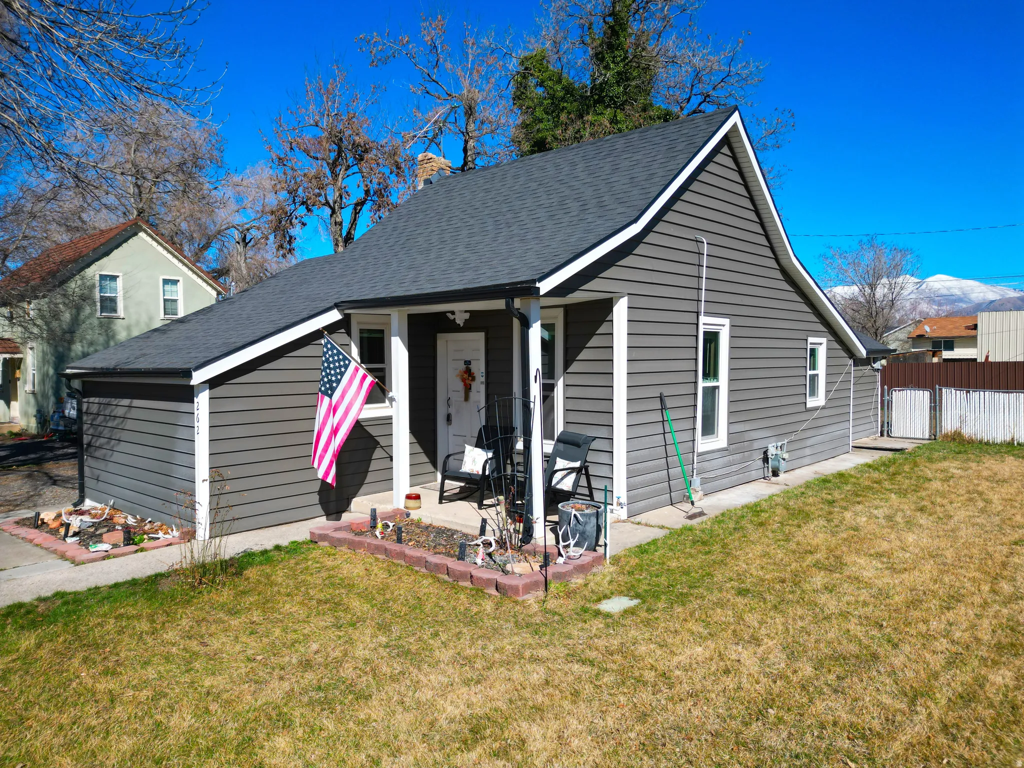 Bungalow-style home with a porch and roof with shingles