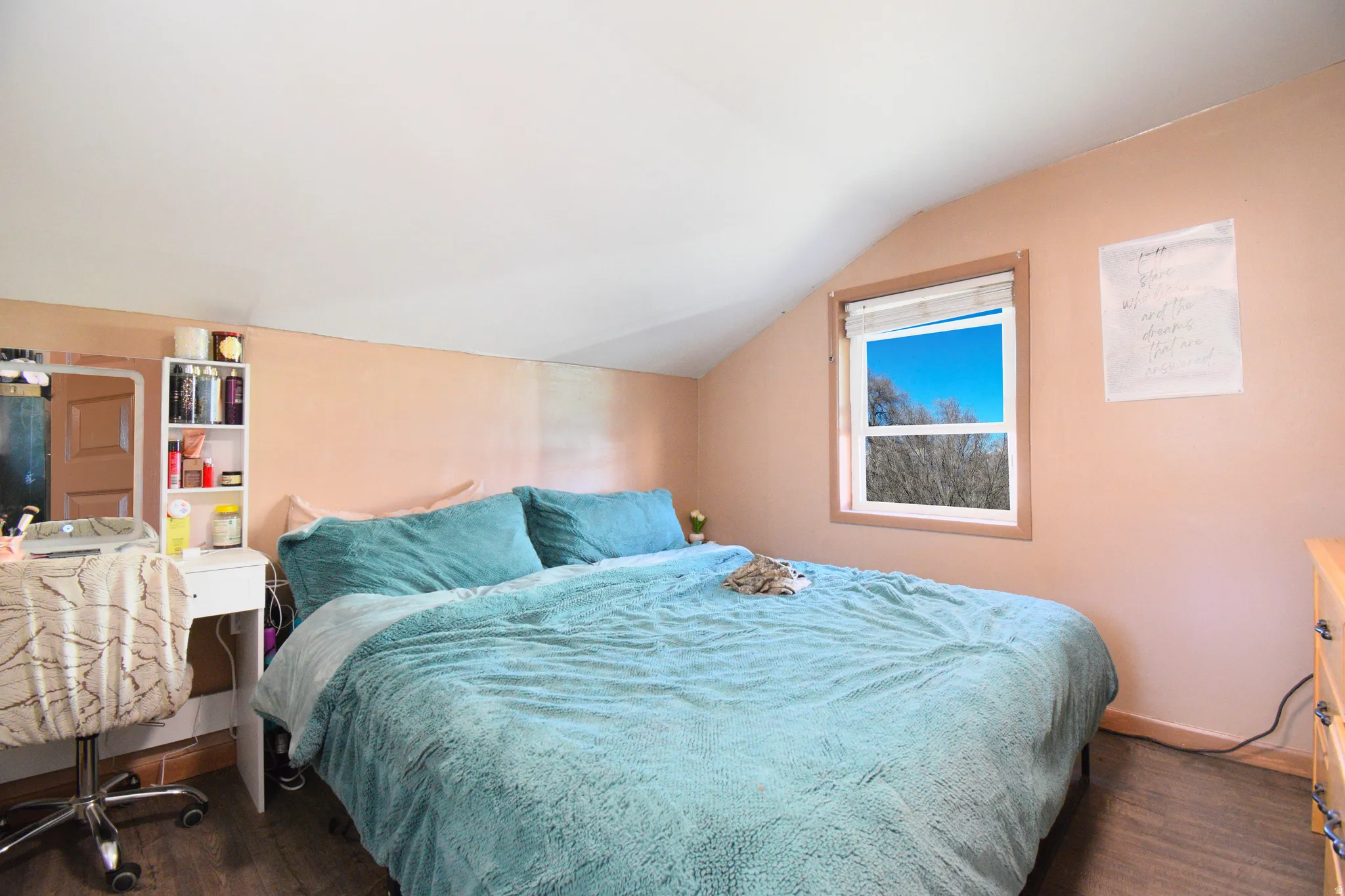 Bedroom with vaulted ceiling, dark wood-style floors, and a desk