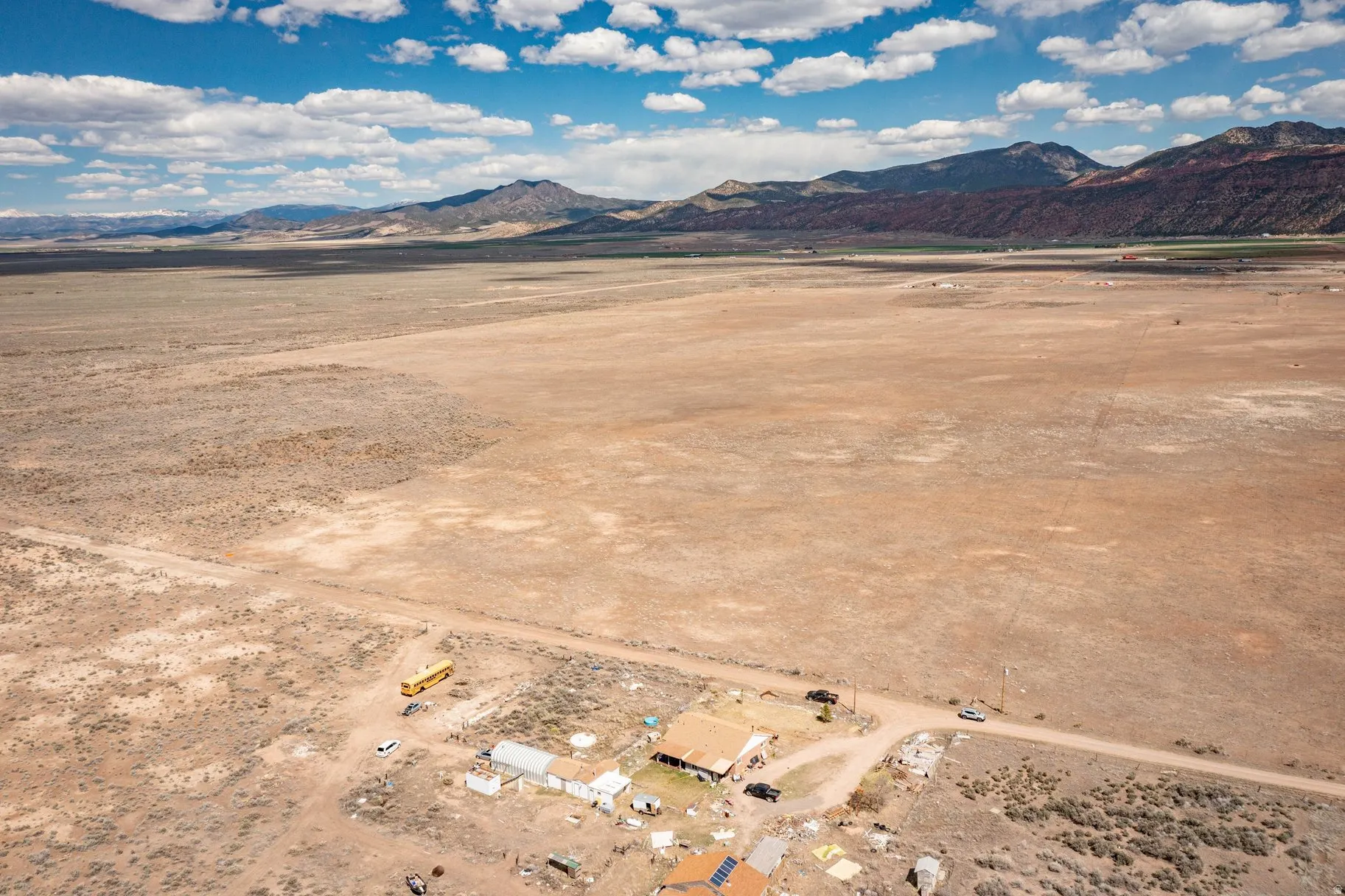 View of mountain backdrop with a desert landscape and rural landscape