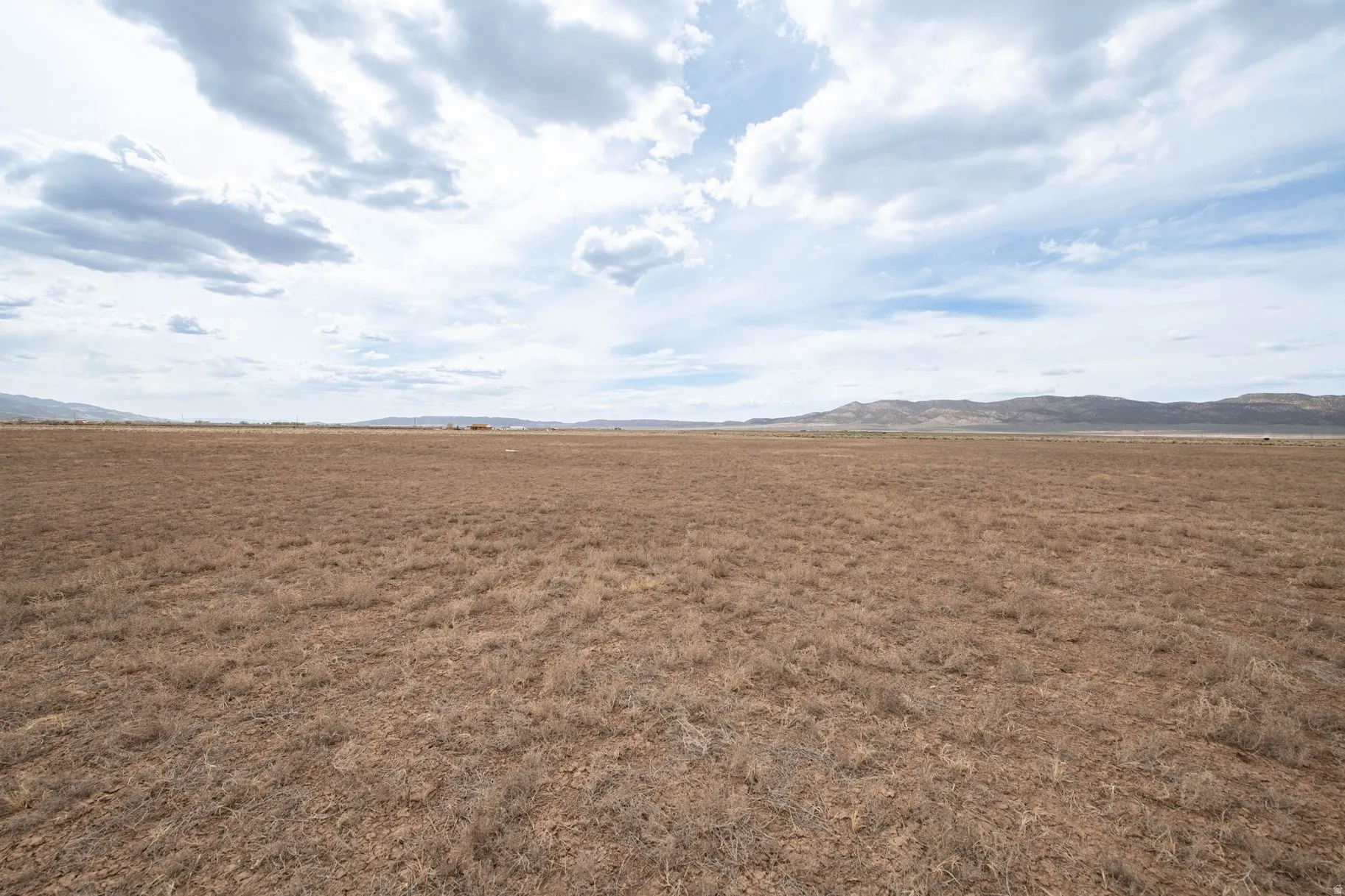 View of undeveloped land with a mountain backdrop and rural landscape
