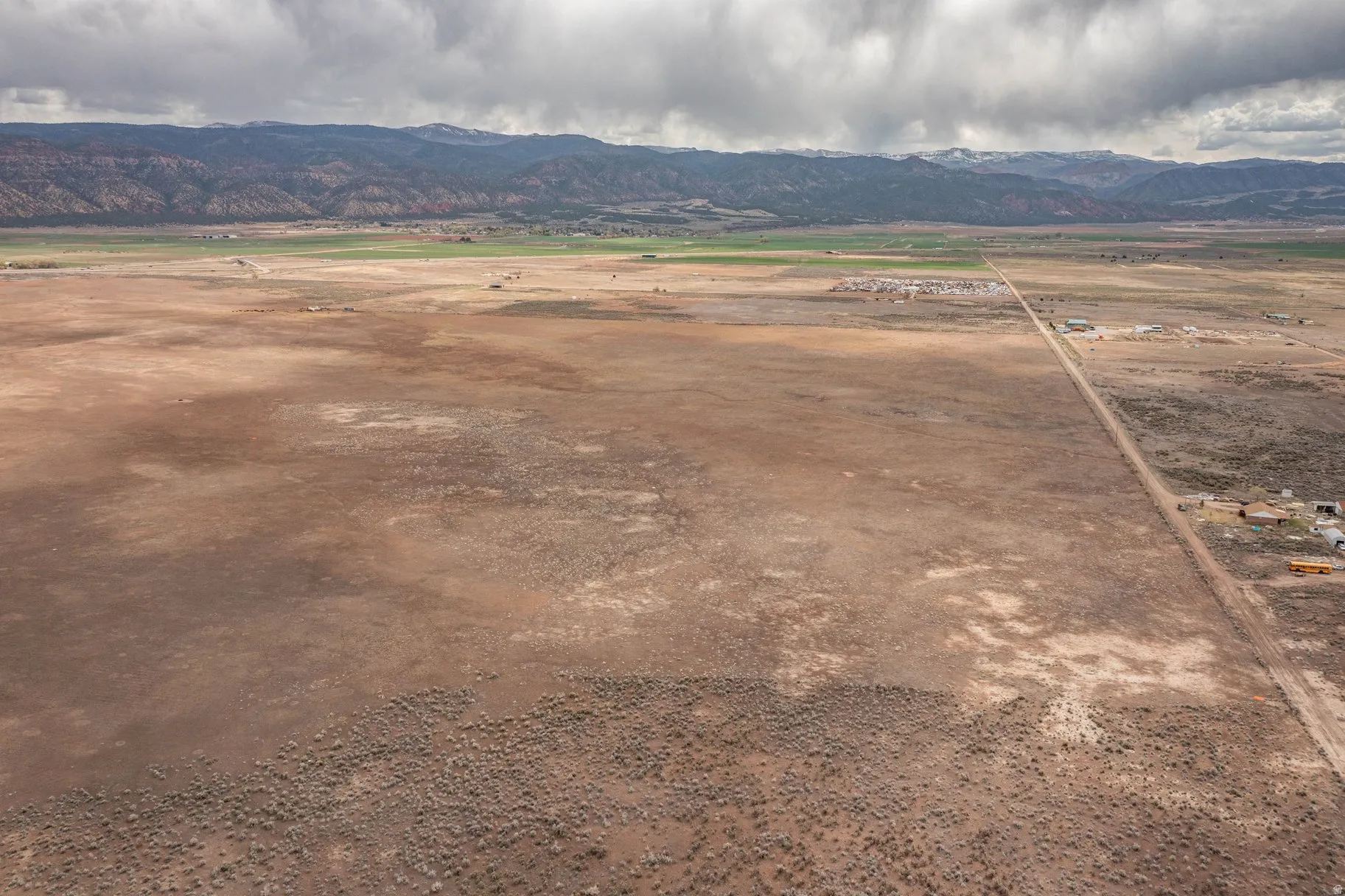 View of mountain backdrop with rural landscape