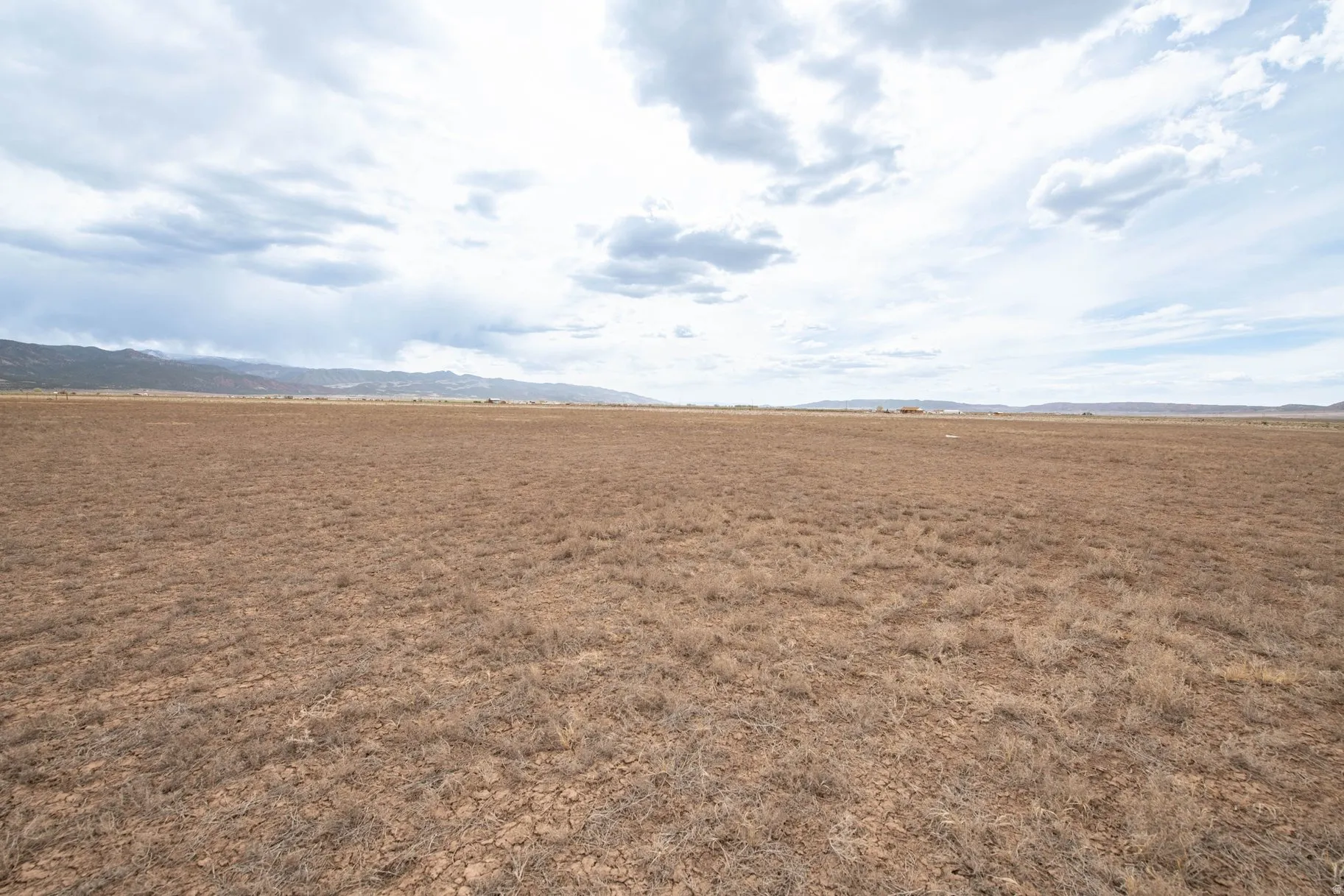 View of undeveloped land with a mountainous background and rural landscape