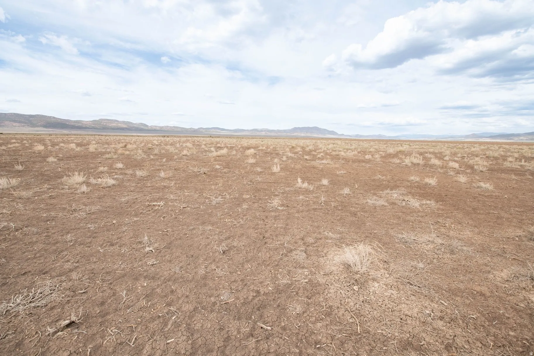 View of local wilderness featuring a mountain backdrop and rural landscape