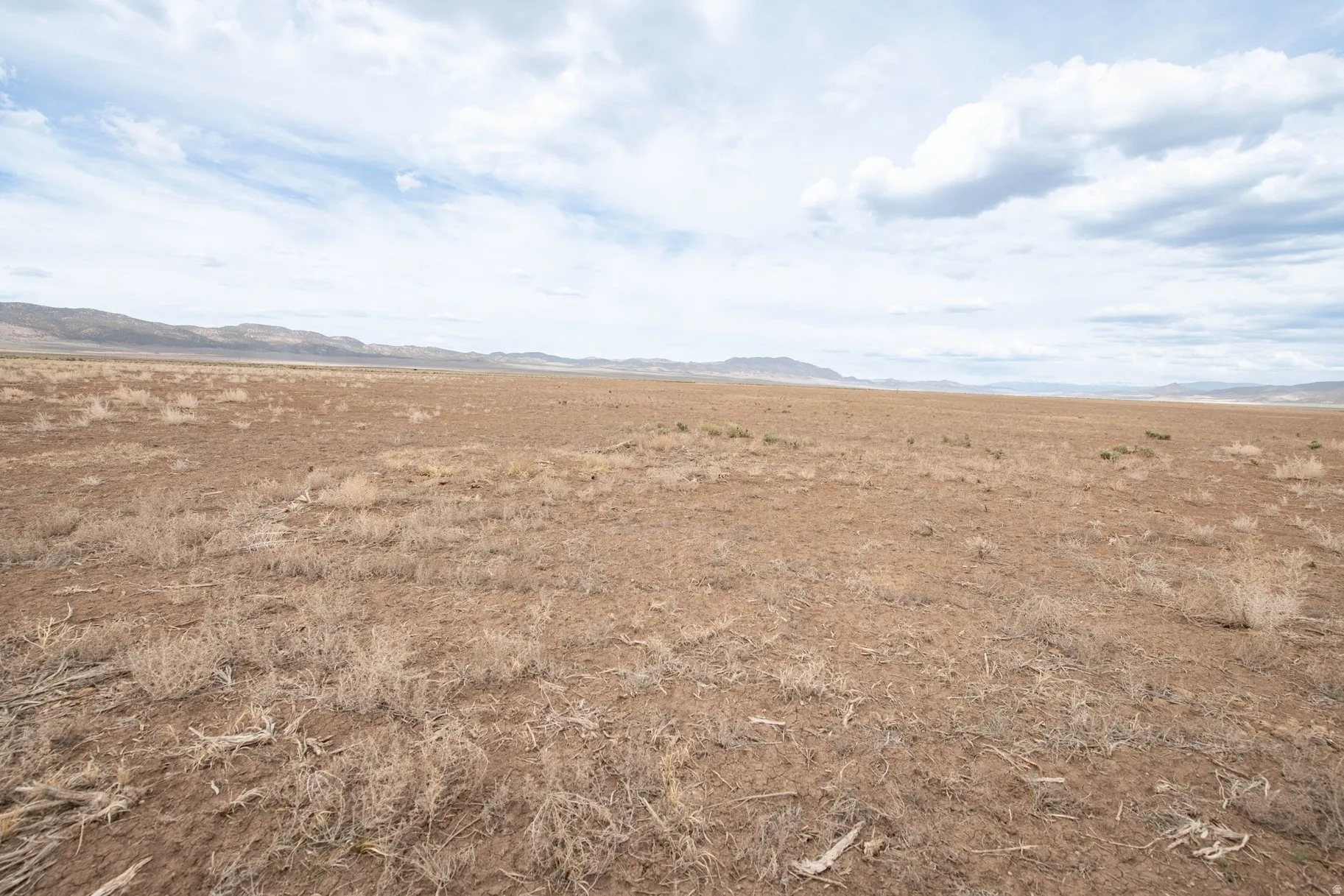View of mountain backdrop with rural landscape