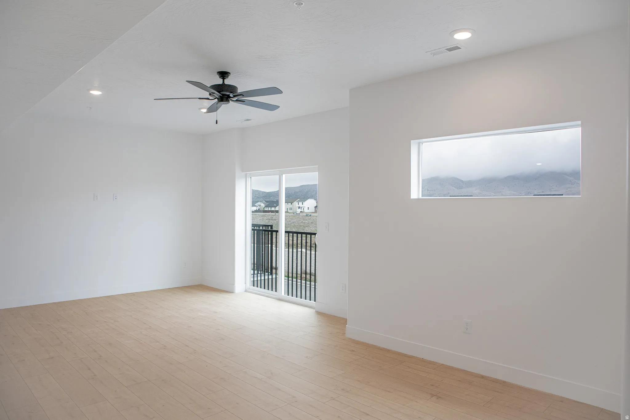 Large family room with ceiling fan.