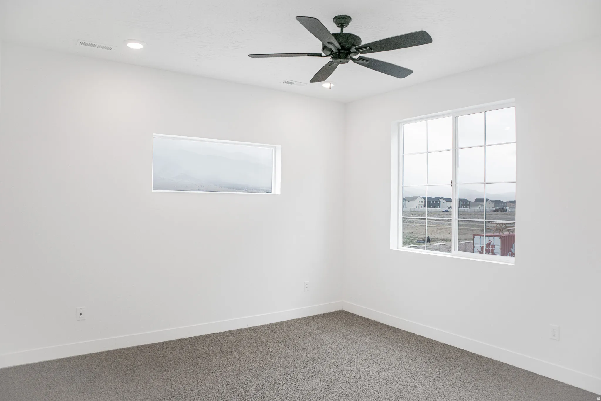 Primary bedroom with ceiling fan.