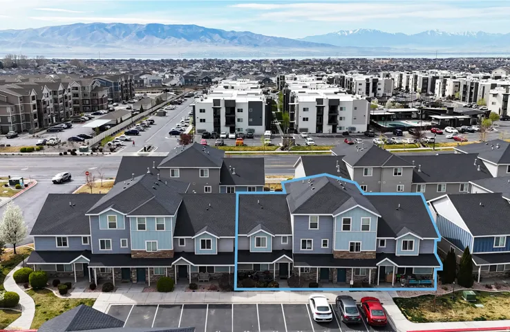Aerial view of property and surrounding area with a mountain backdrop and property boundaries highlighted