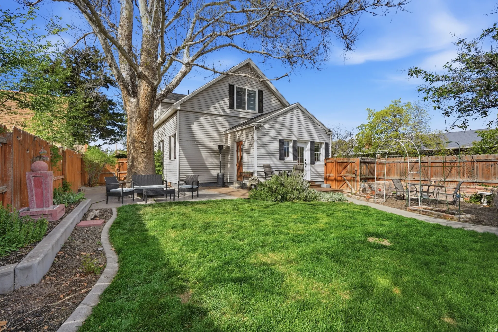 Rear view of property with a patio area and a fenced backyard