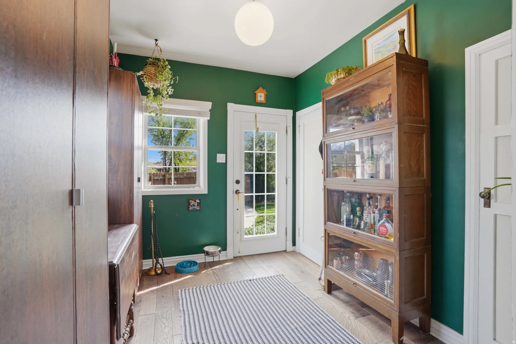 Doorway featuring wood finished floors and baseboards