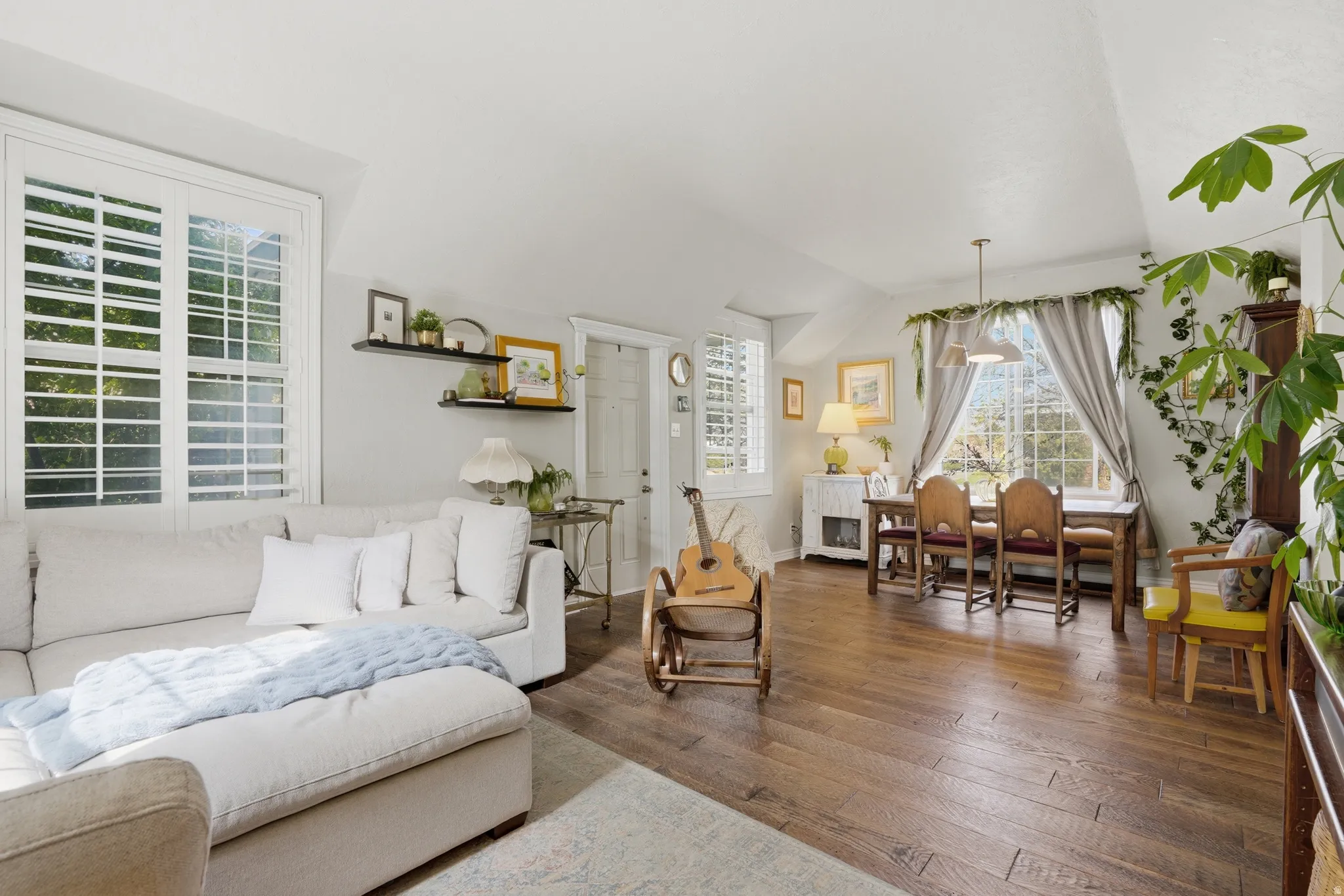 Living room with lofted ceiling and hardwood / wood-style flooring