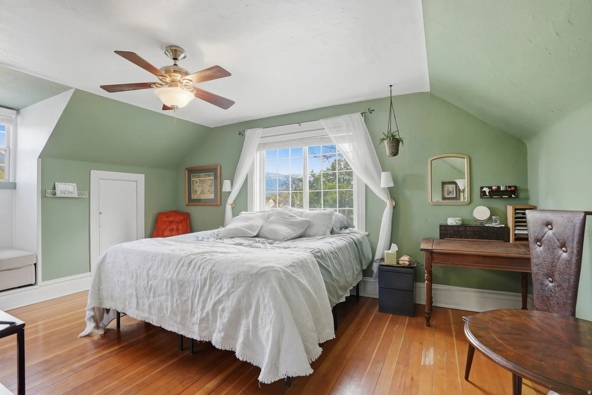 Bedroom featuring vaulted ceiling, light wood-type flooring, and ceiling fan