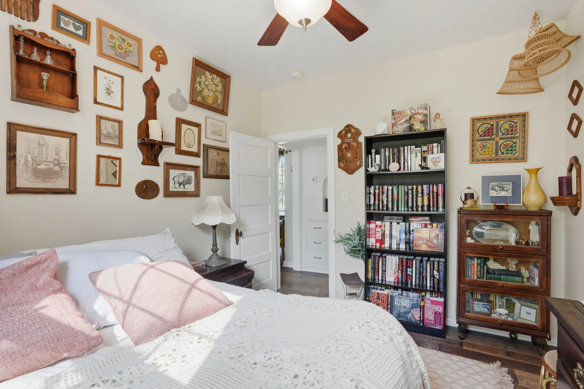Bedroom with dark wood-style floors and a ceiling fan