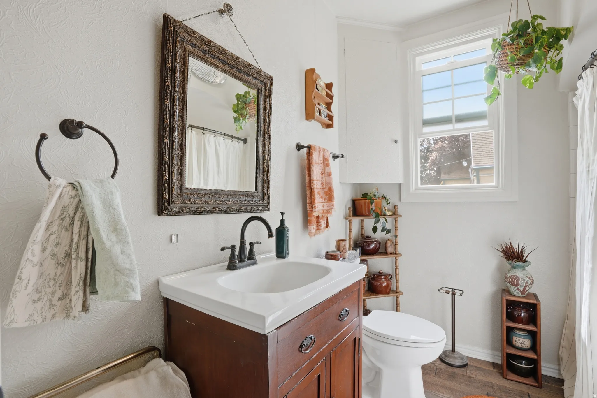 Bathroom featuring a shower with shower curtain, vanity, and wood finished floors
