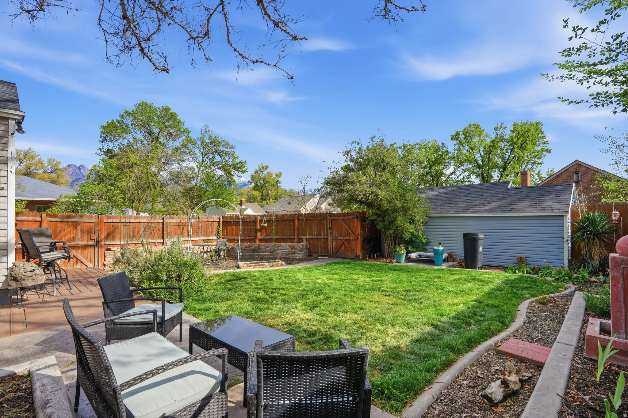 Fenced backyard with a patio and a gate