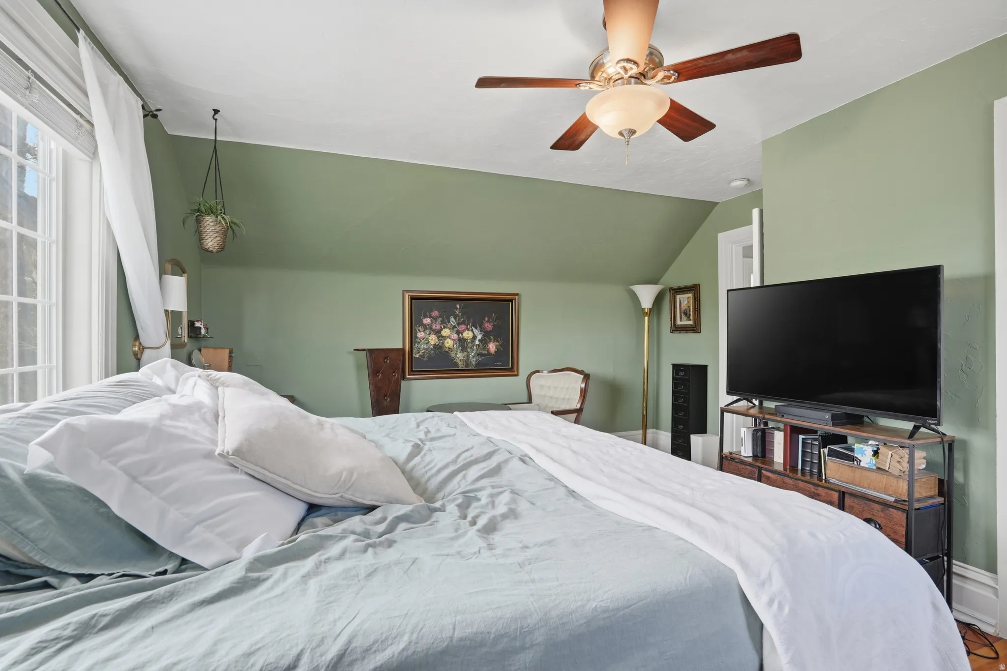Bedroom with ceiling fan and lofted ceiling