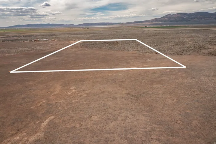 Overview of rural landscape featuring mountains and property parcel outlined