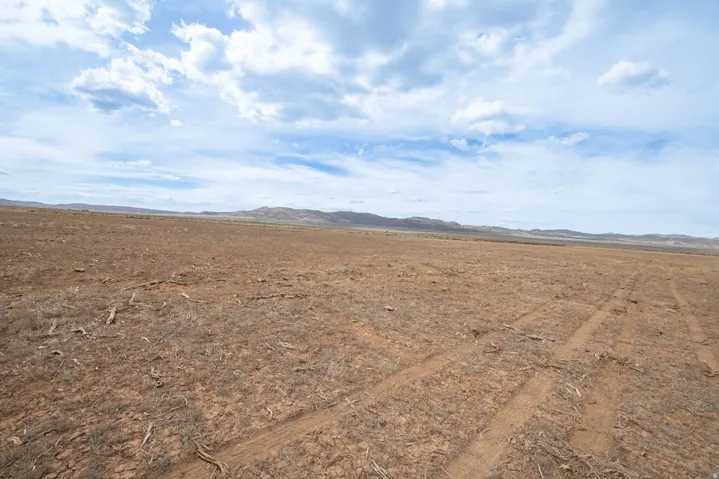 View of undeveloped land with a mountainous background and rural landscape