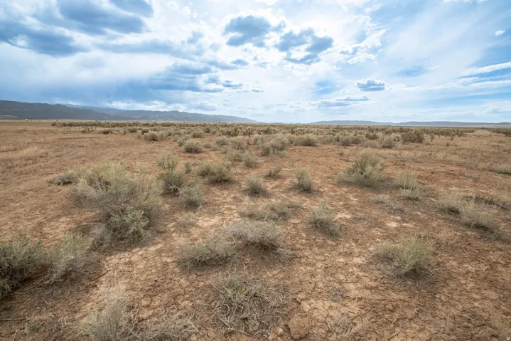 View of undeveloped land featuring mountains and rural landscape