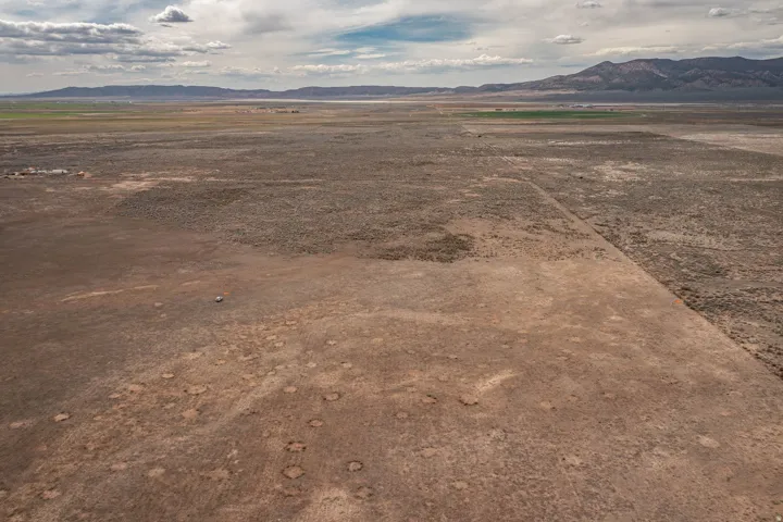 View of mountain backdrop with rural landscape and a desert landscape