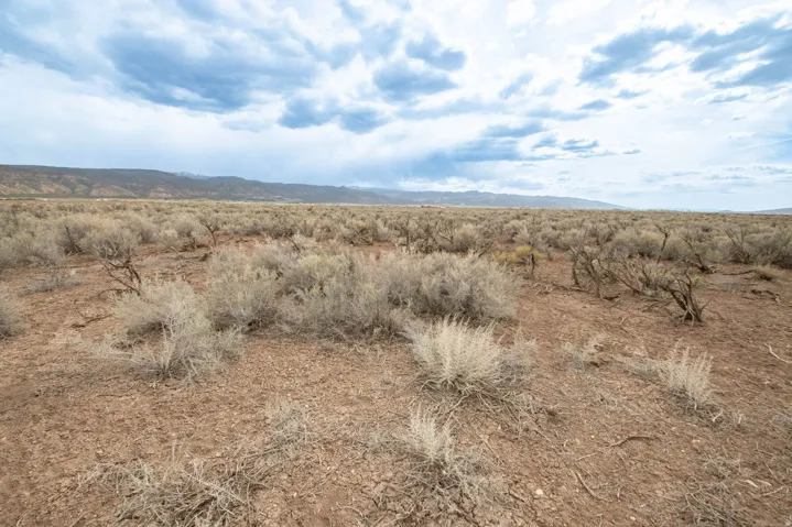 View of undeveloped land featuring mountains and rural landscape
