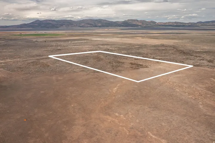 Overview of rural landscape featuring mountains and property parcel outlined
