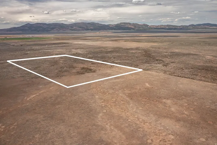 View of parking with a mountain view, a rural view, and a desert view