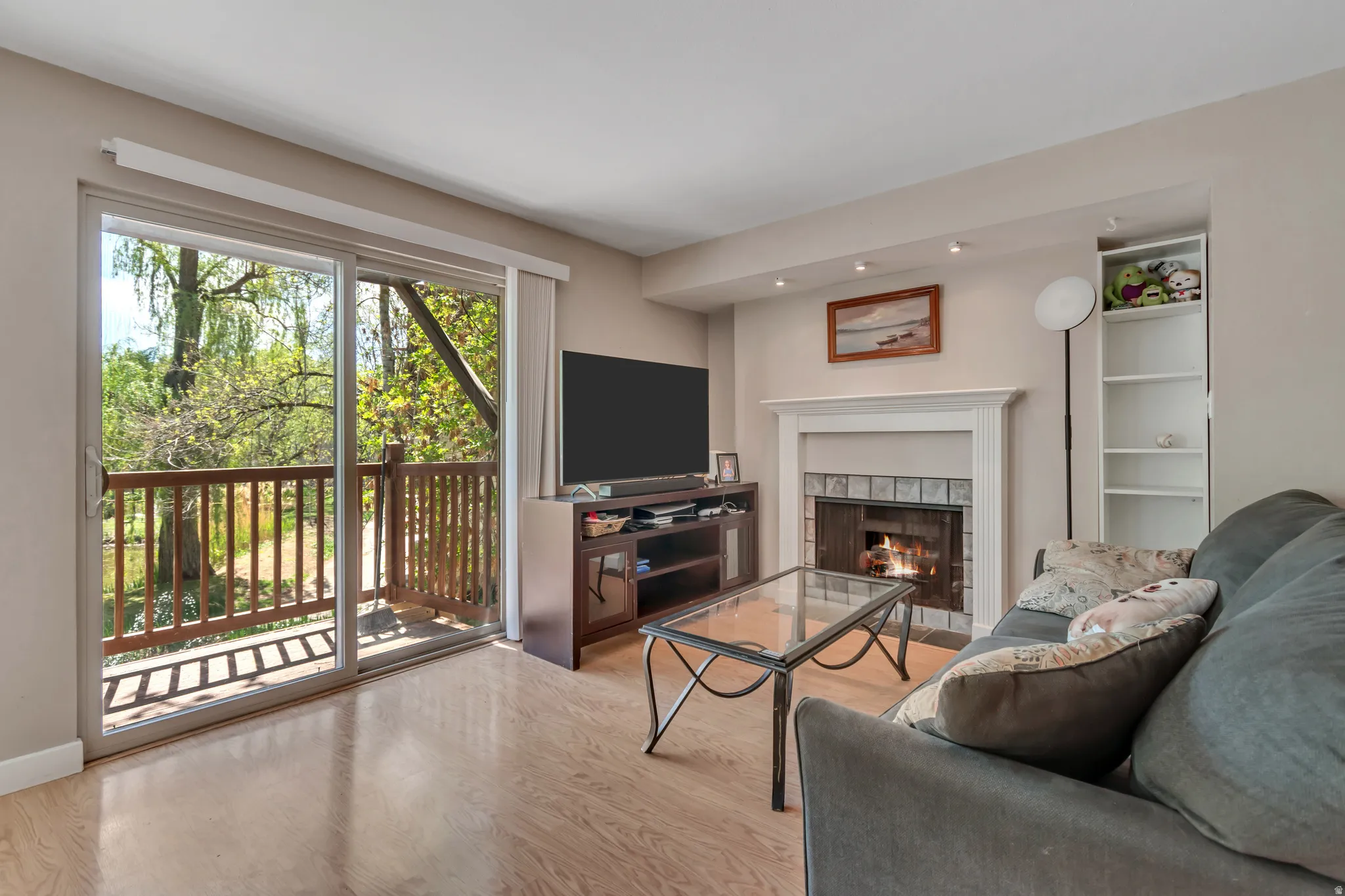 Living room featuring light wood-type flooring and a fireplace
