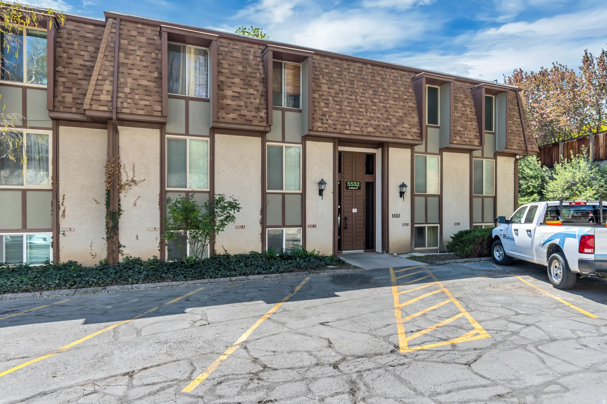 View of building exterior with uncovered parking