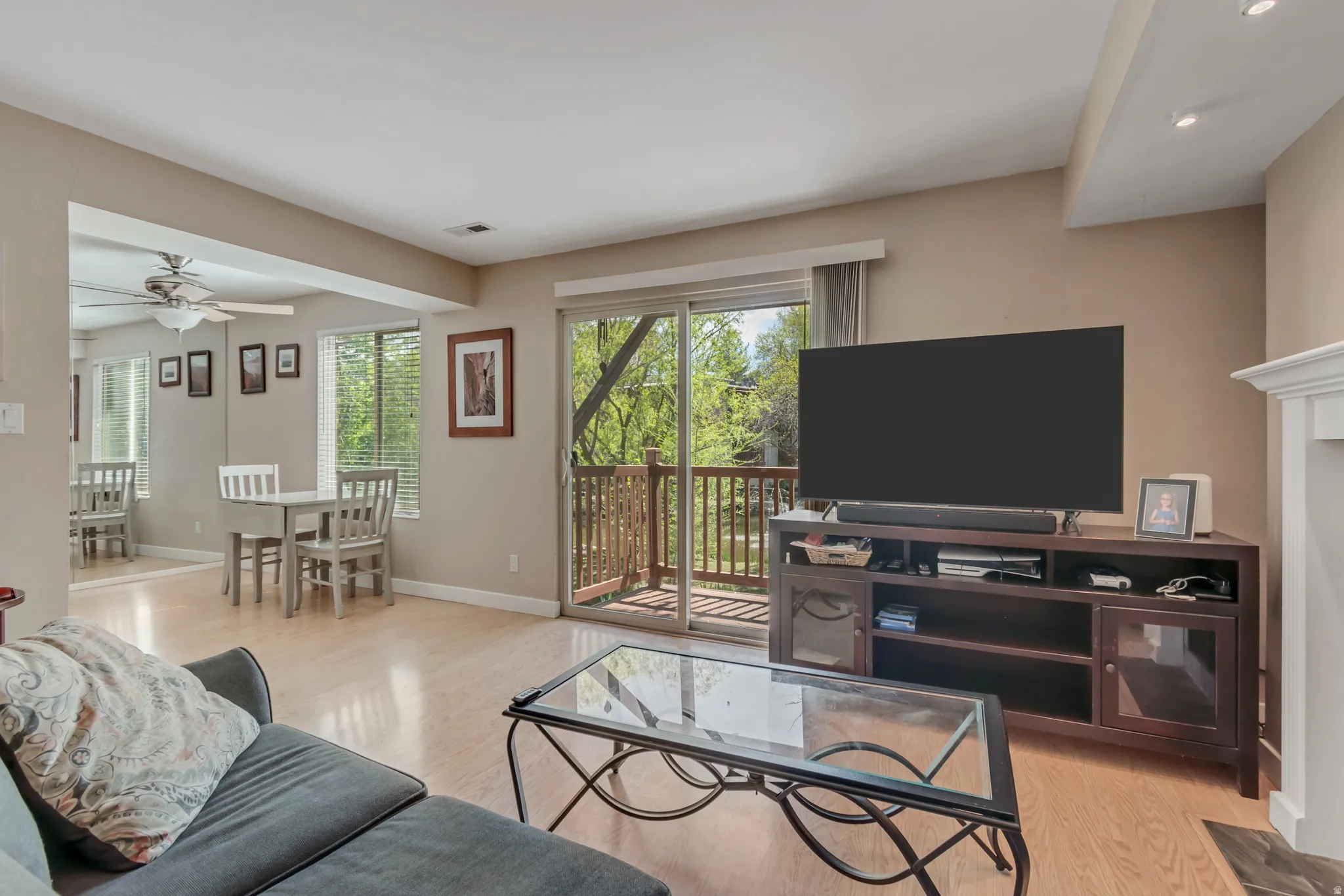 Living room featuring light wood-style floors and a ceiling fan
