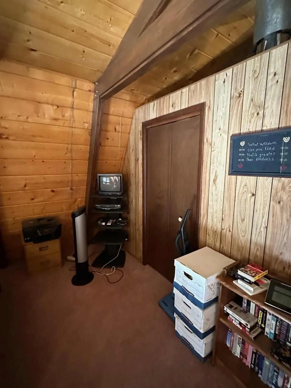 Sitting room featuring wood walls, dark colored carpet, and a vaulted wooden ceiling