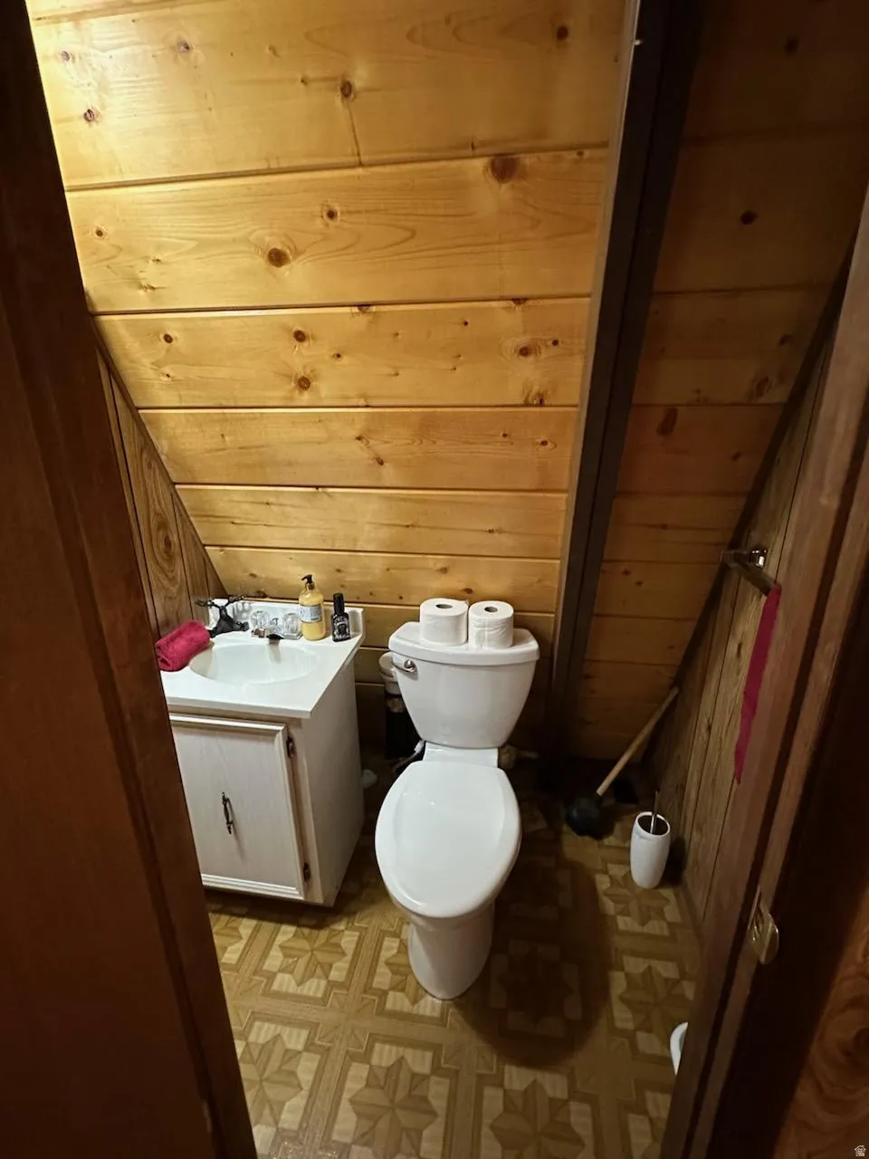 Bathroom with wood walls, vanity, and wooden ceiling