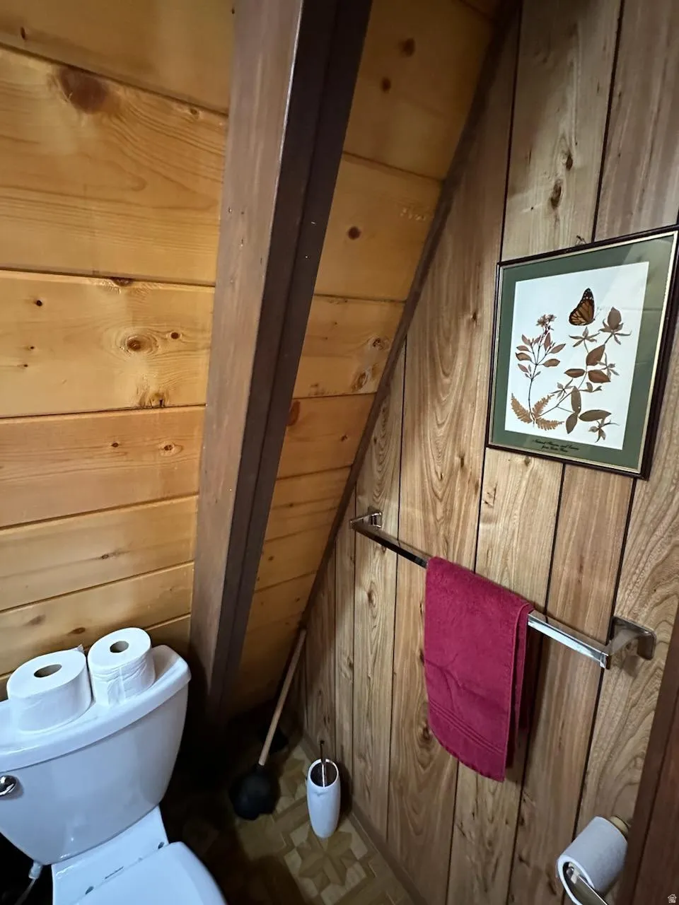 Bathroom with wood walls and toilet