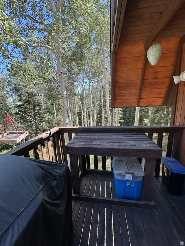 Wooden deck featuring a grill