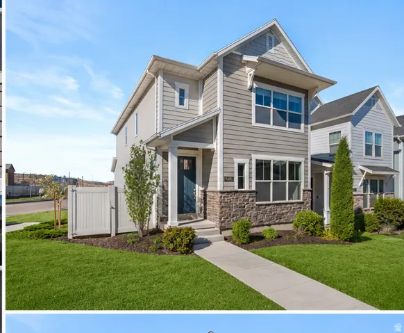 Contemporary two-story exterior featuring a prominent gabled roofline, mixed material siding, stone veneer accents, an inviting covered front entry, and a manicured lawn