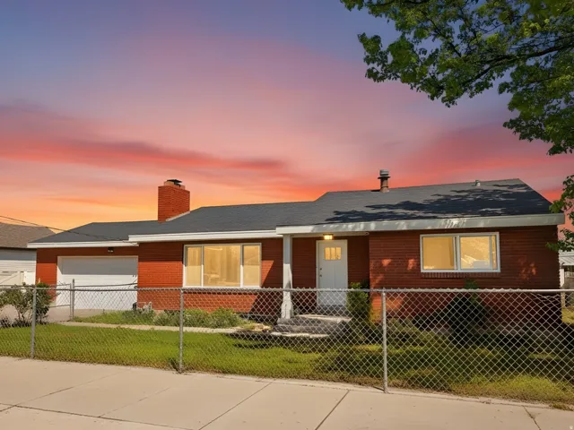 Brick exterior residence featuring a single-car garage with a white door
