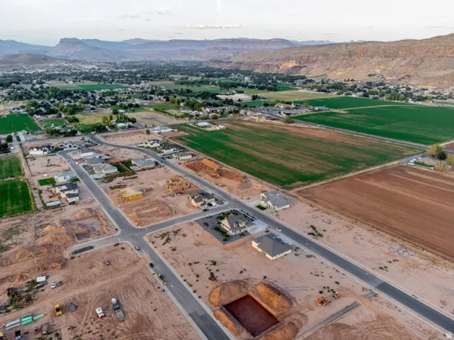 Aerial overview of property's location featuring a mountainous background and rural landscape