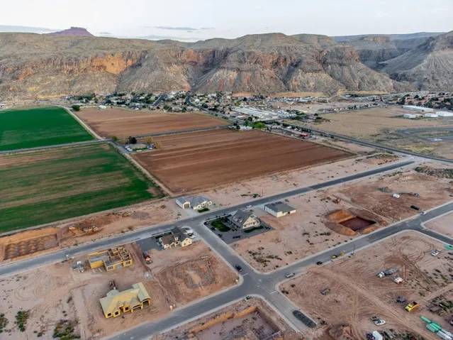 Aerial overview of property's location with a mountain backdrop and rural landscape