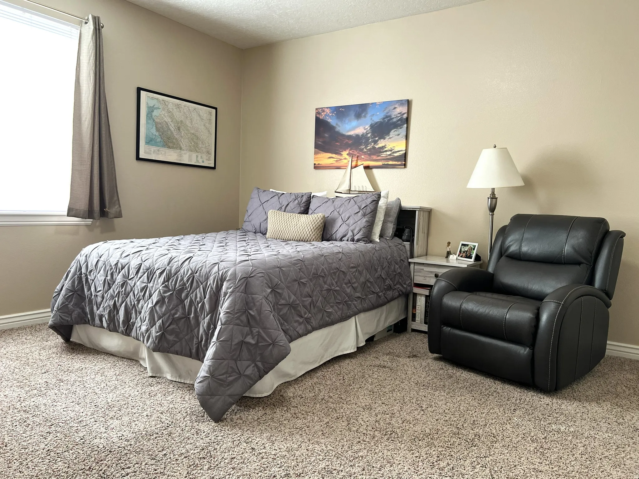 Carpeted bedroom featuring baseboards and a textured ceiling