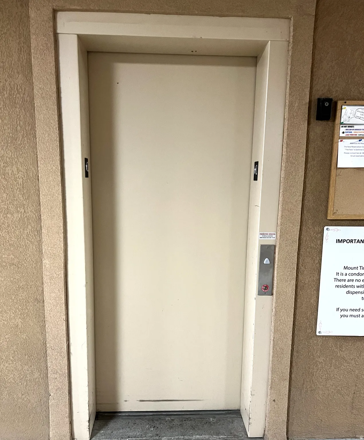 View of exterior entry featuring elevator and stucco siding