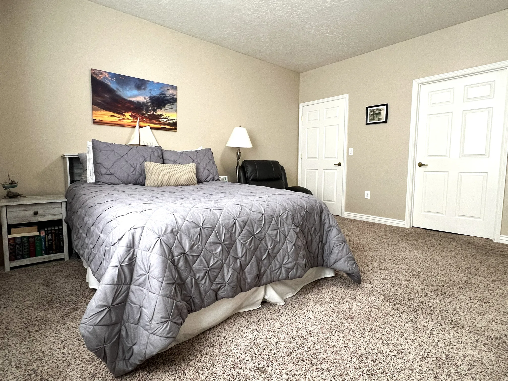 Bedroom featuring carpet flooring and a textured ceiling