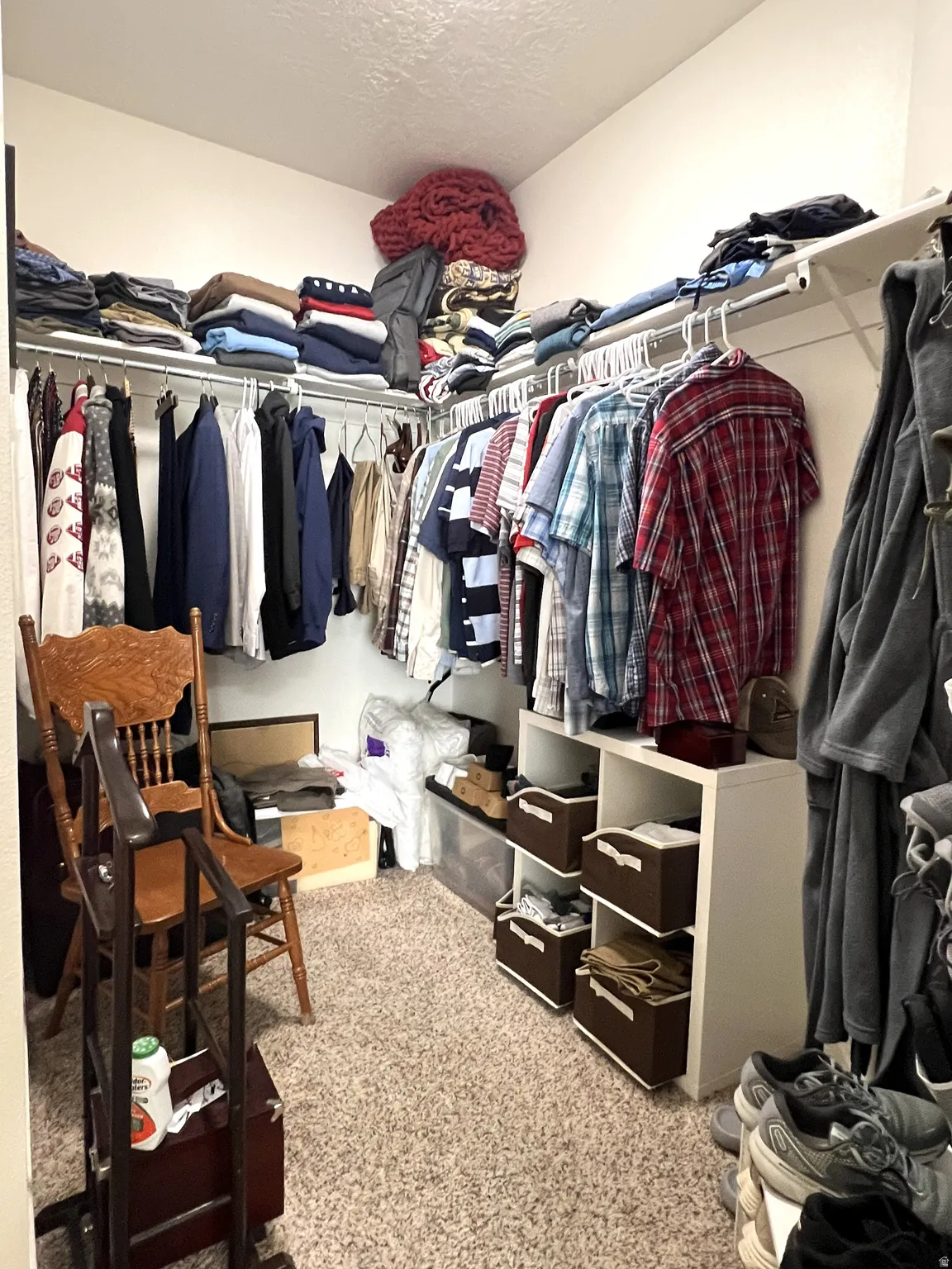 Walk in closet with light colored carpet