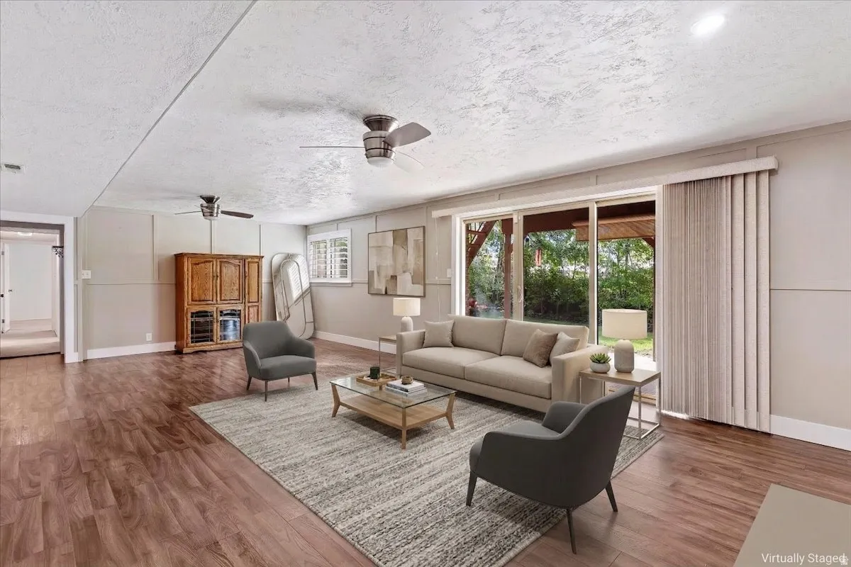 Virtually staged Living area with wood finished floors, ceiling fan, and a textured ceiling