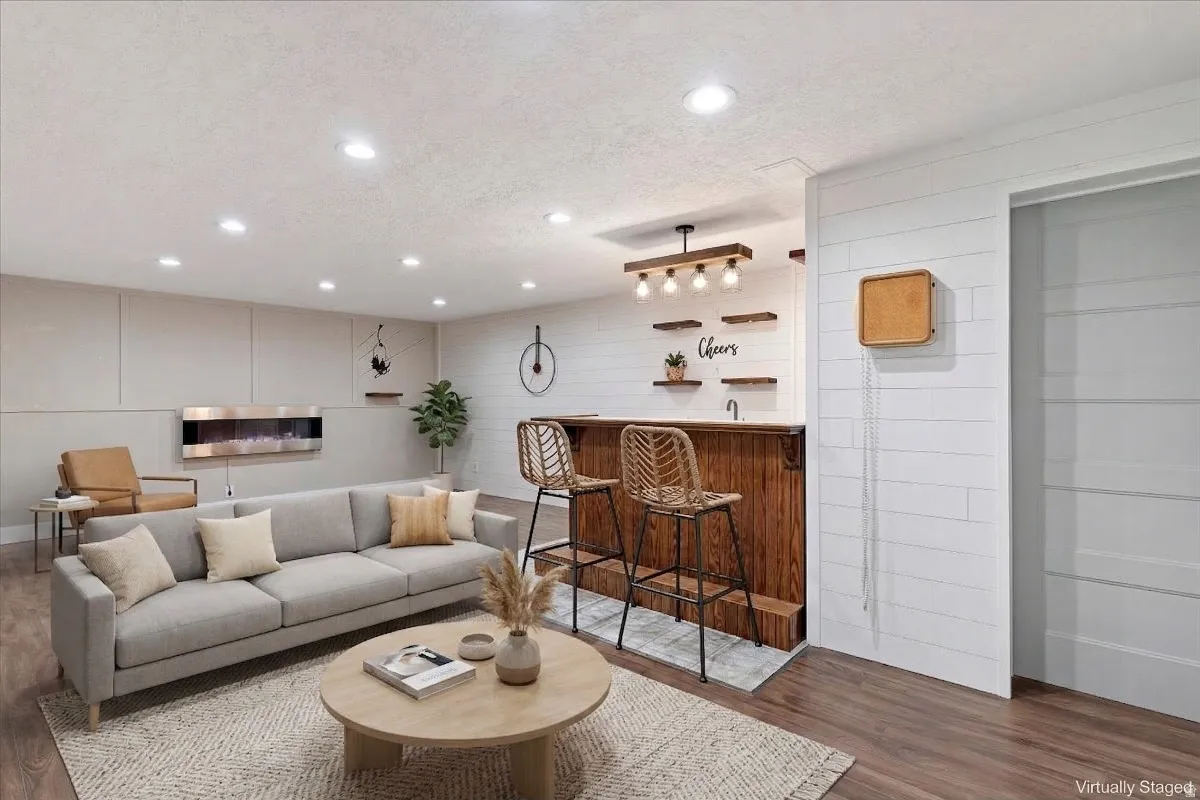 Virtually staged  Living room with dark wood-type flooring, a textured ceiling, recessed lighting, and bar with sink