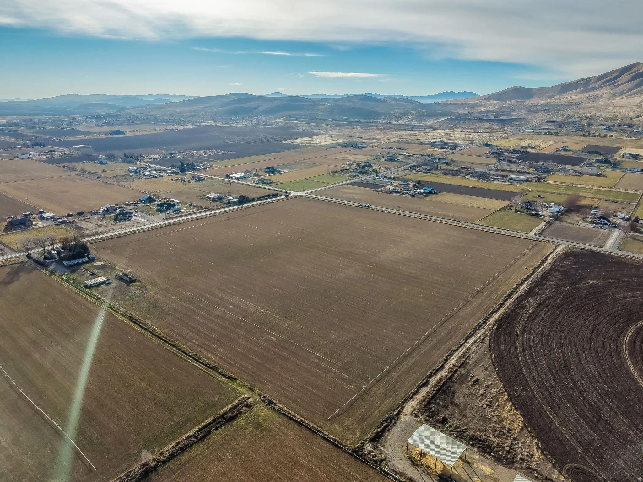 Aerial overview of property's location featuring rural landscape and a mountain backdrop