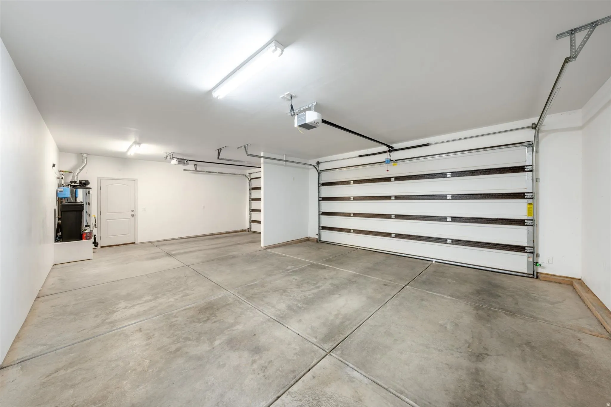 Garage with water heater and a garage door opener