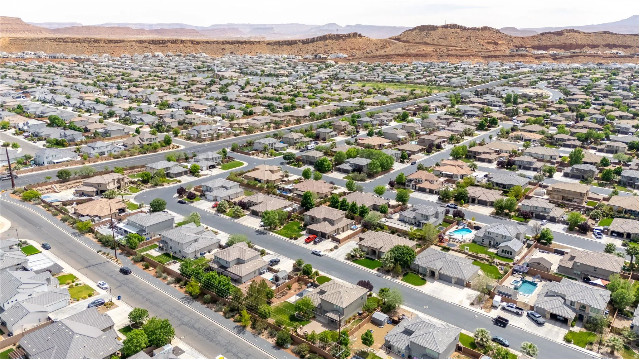 Aerial perspective of suburban area featuring a mountainous background