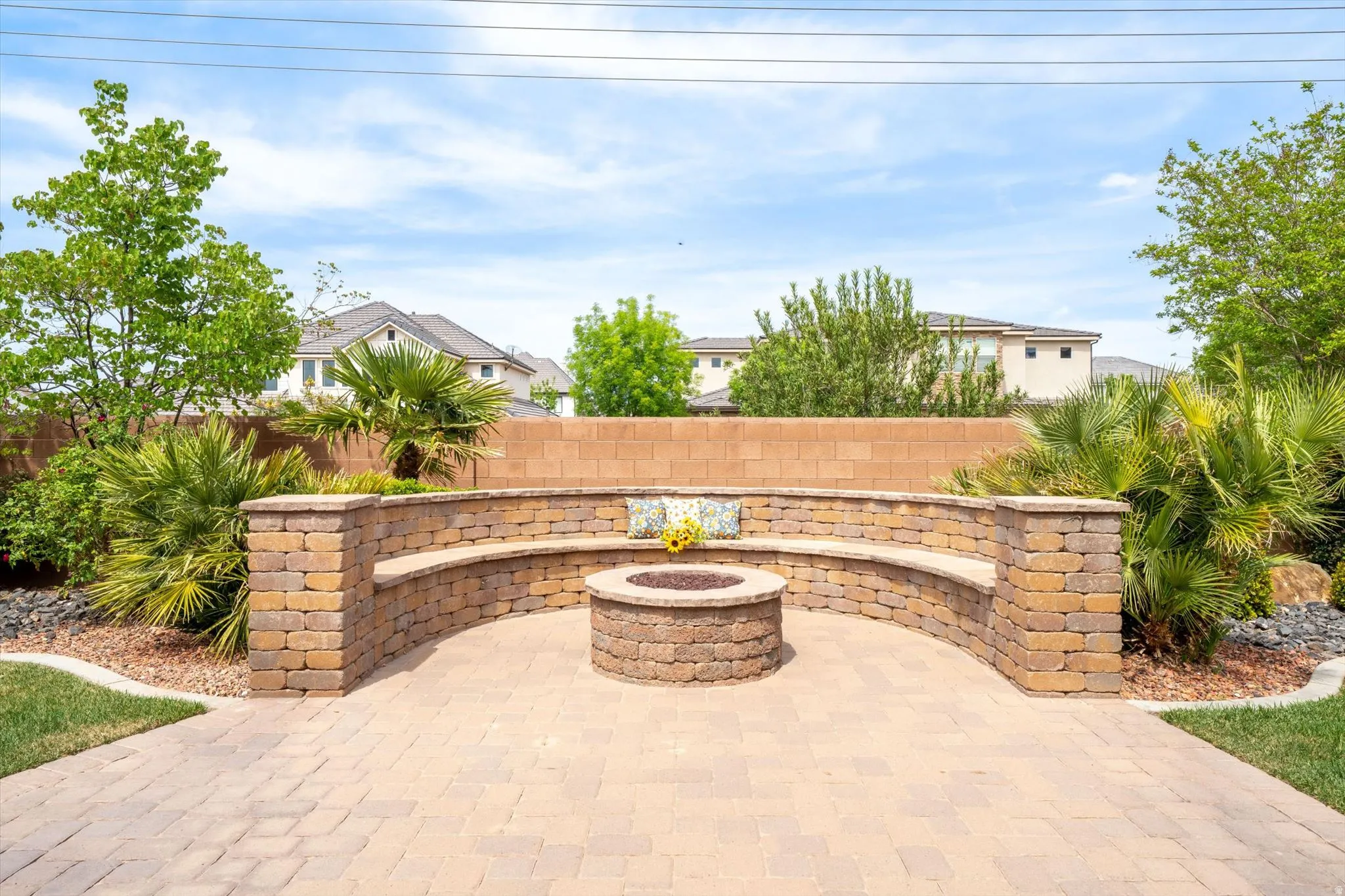 Fenced backyard featuring a fire pit and a patio area